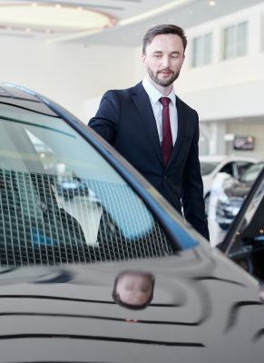 Man choosing a car with car dealer
